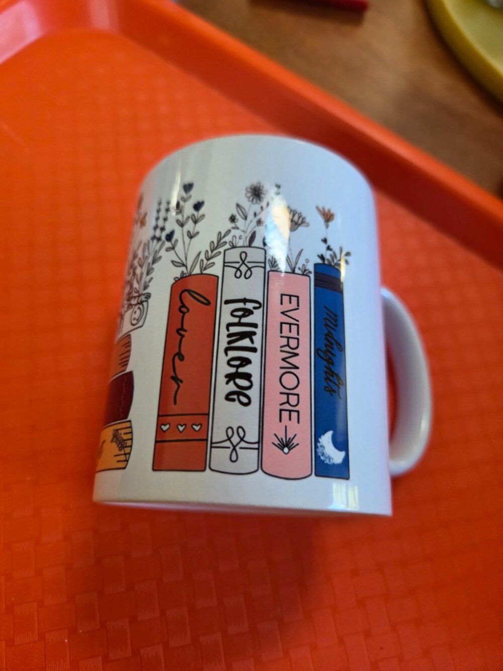 mug featuring Taylor Swift stacked bok spines of her albums